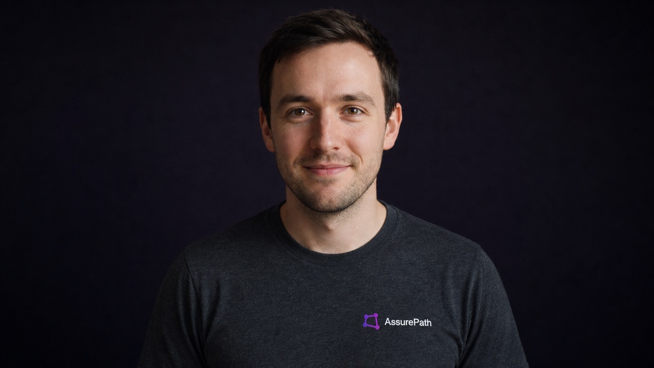 Ellis, AssurePath's AI receptionist, in an AssurePath tee against a dark background